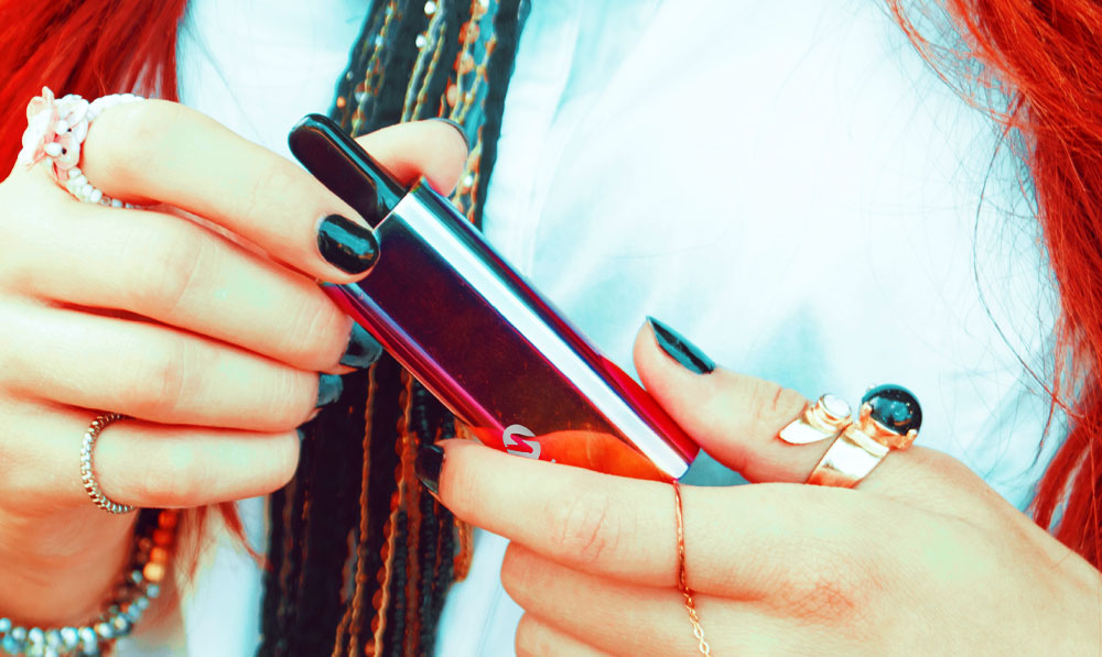 Woman holding Sutra Auto with bright lighting