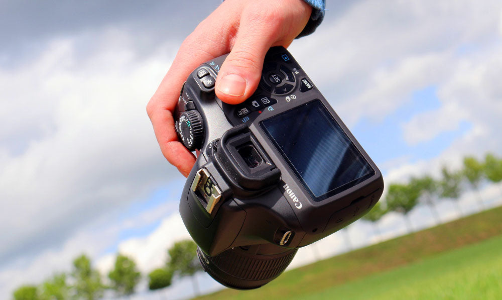Person holding camera outside on an overcast day