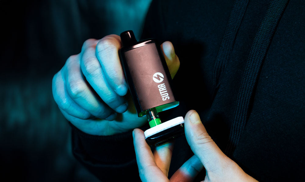 Man holding Sutra SILO Pro in front of dark background