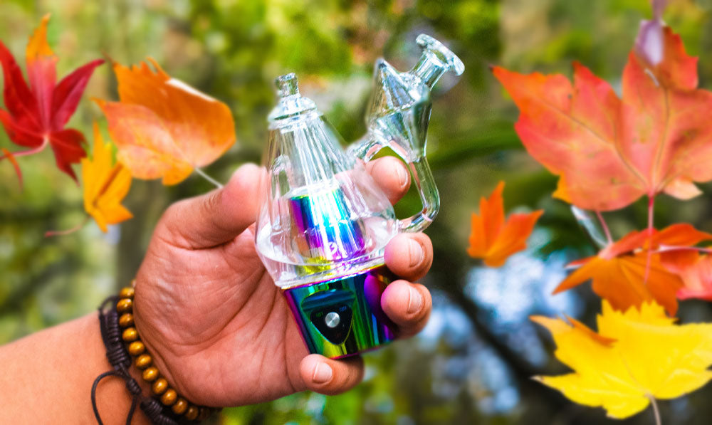 Man holding Sutra DBR Pro over lake with autumn leaves falling
