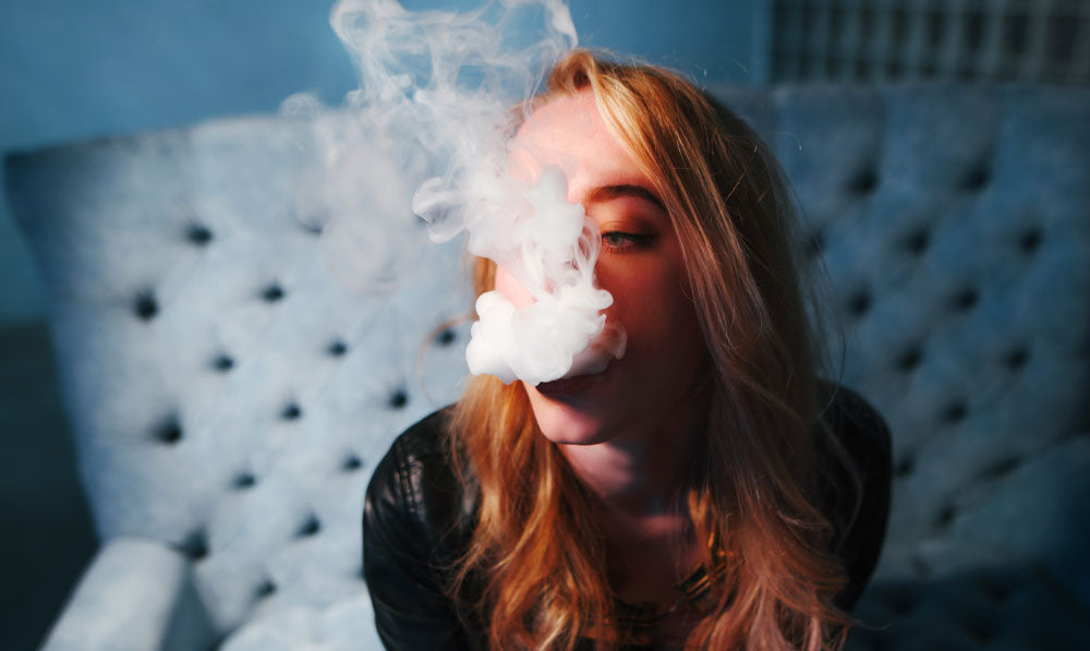 Woman vaping slowly