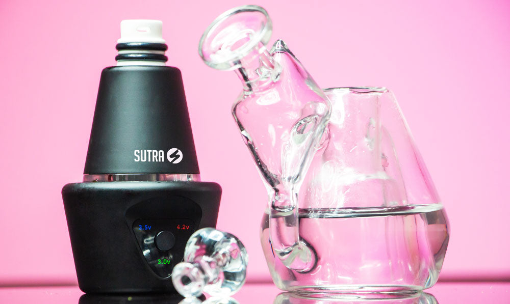 Sutra DBR Pro electronic rig with its glass attachment separated, against a pink background