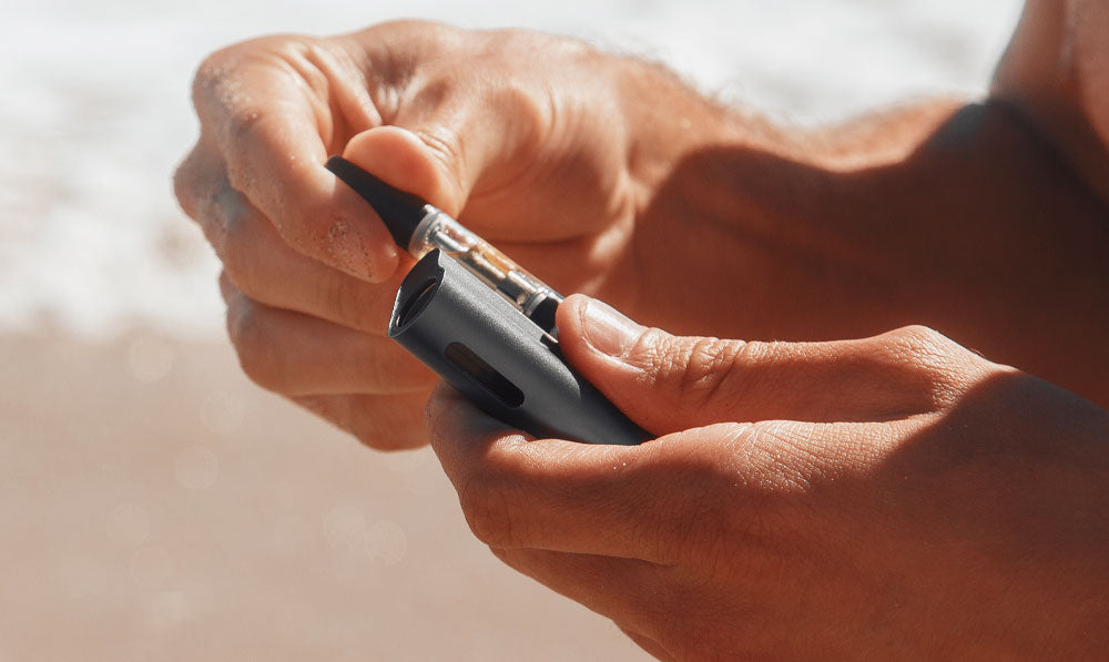 Man holding Sutra Auto at the beach