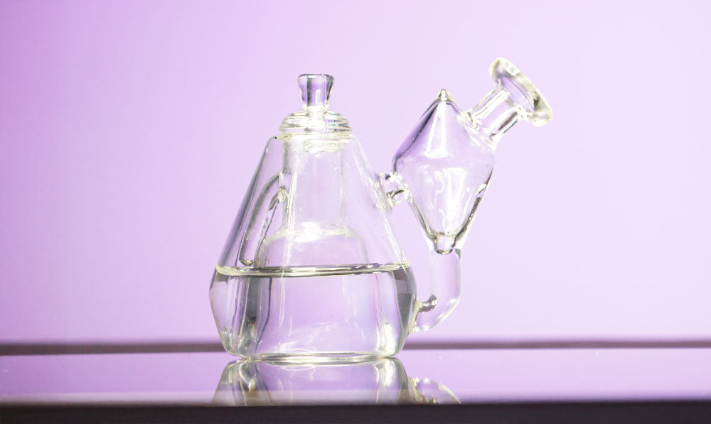Sutra DBR Pro glass on reflective surface in front of purple studio background