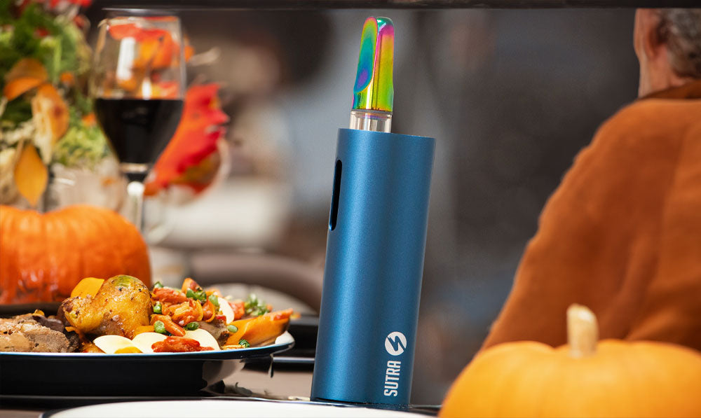 Sutra Auto vaporizer on a table set for Thanksgiving dinner
