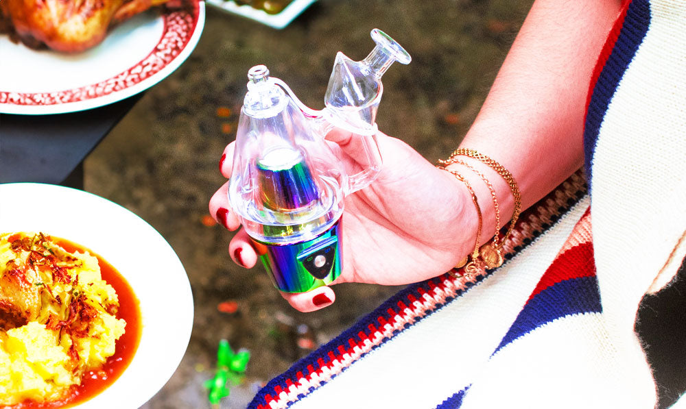 Woman holding Sutra DBR Pro with Thanksgiving dinner nearby