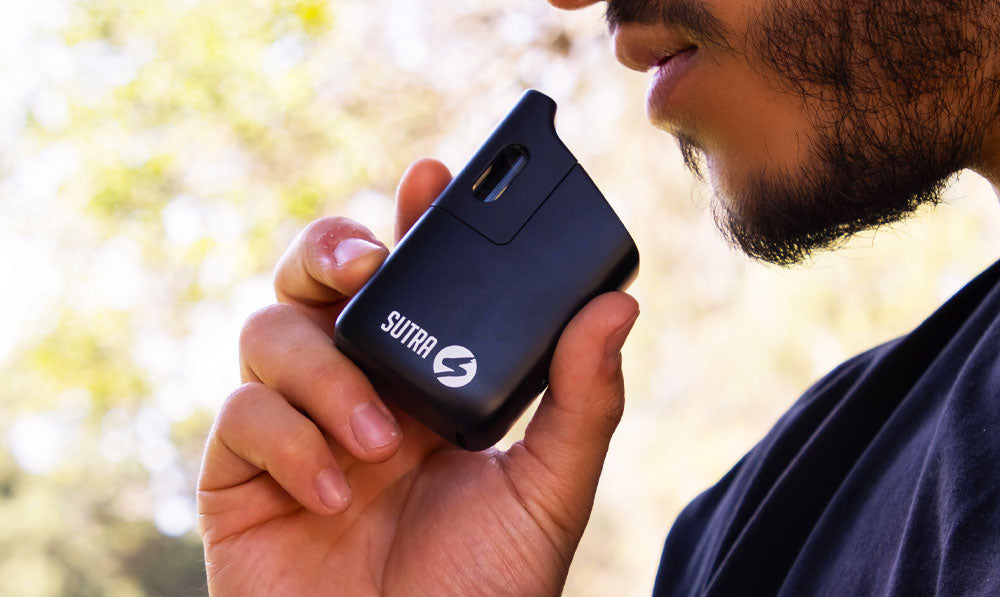 Man holding Sutra Mini near nature trail