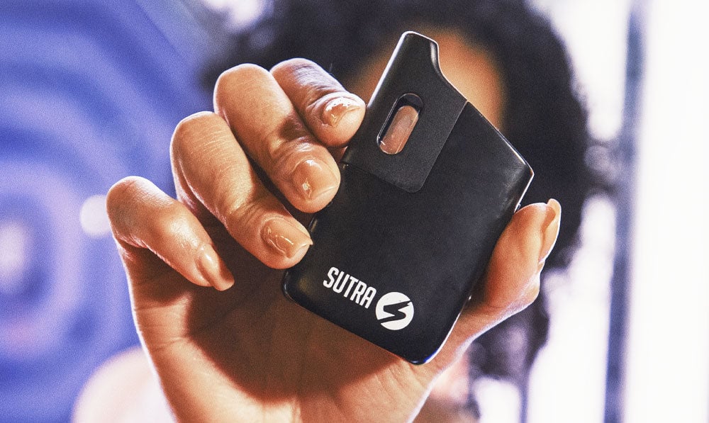 Woman holding Sutra Mini in an arcade