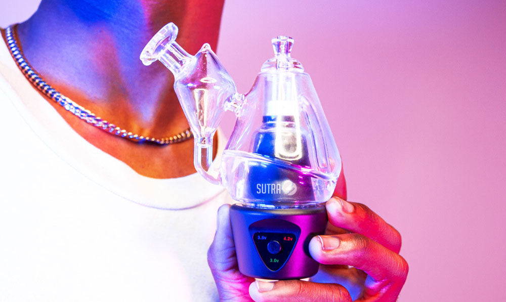 Man holding Sutra DBR Pro in front of blue and purple studio background