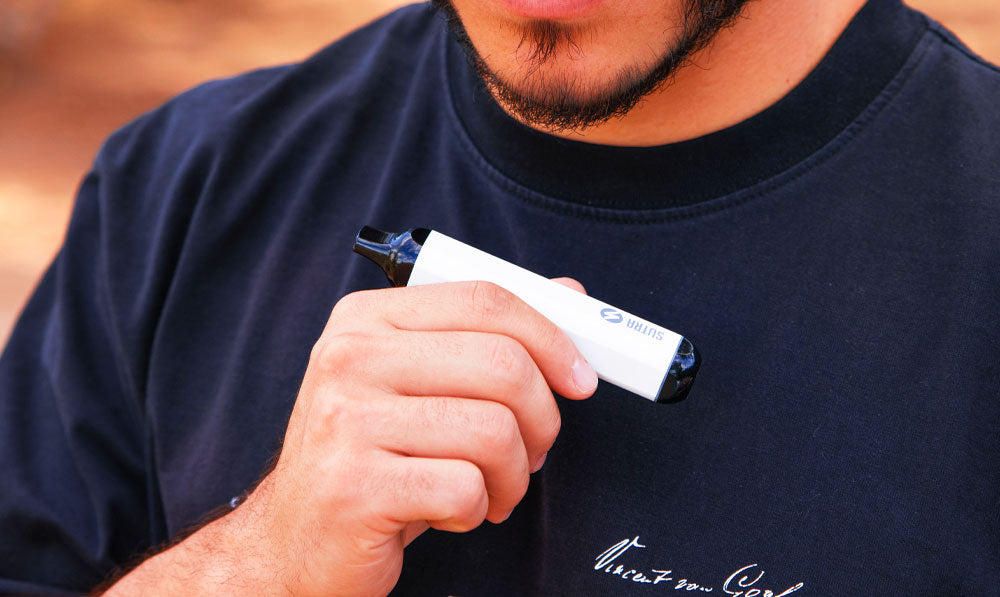 Man holding Sutra SILO close to chest on a park trail