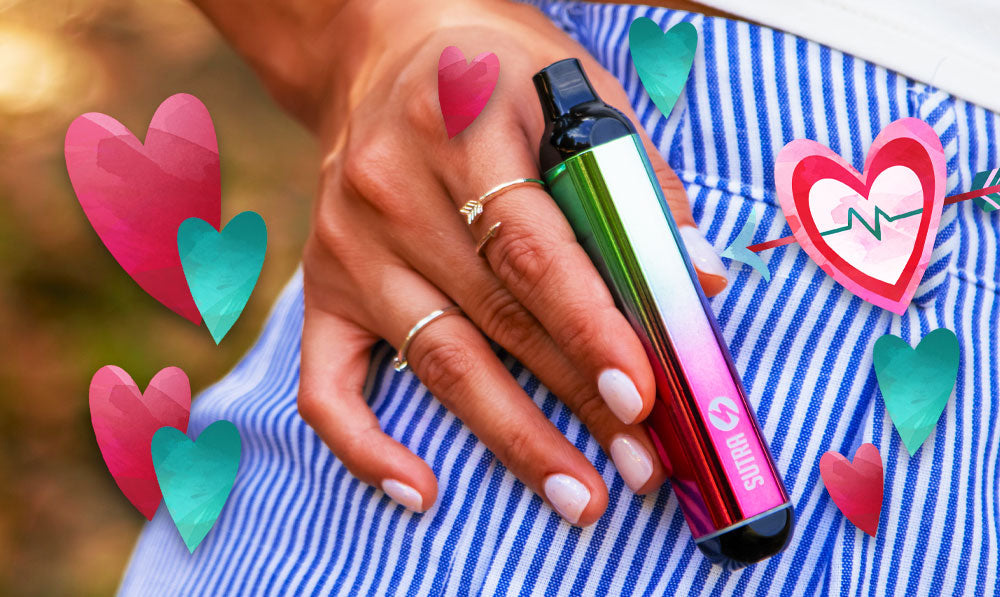 Person holding a Sutra Silo 510 thread battery with heart decorations
