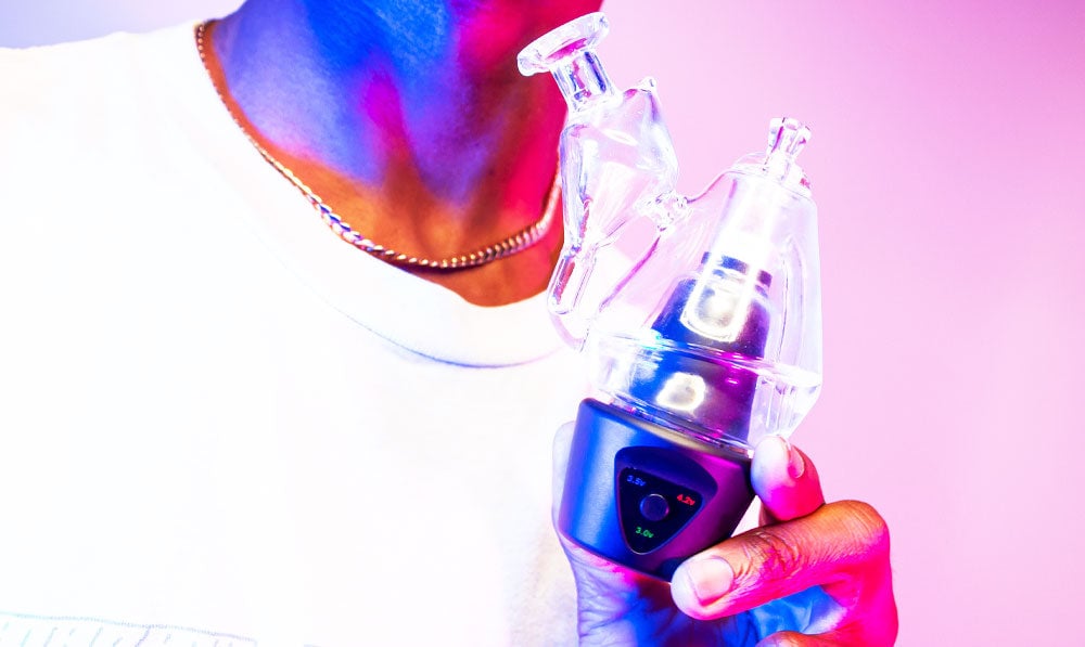 Man holding Sutra DBR Pro in front of pink studio background