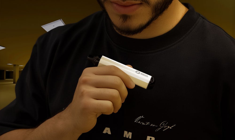 Man in Backrooms style atmosphere holding Sutra Vape SILO in his hand