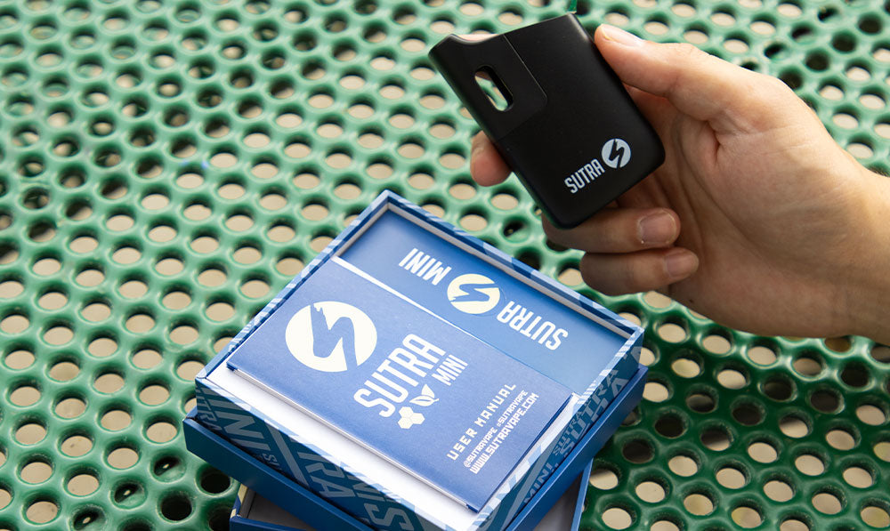 sutra mini on a park bench lifestyle image