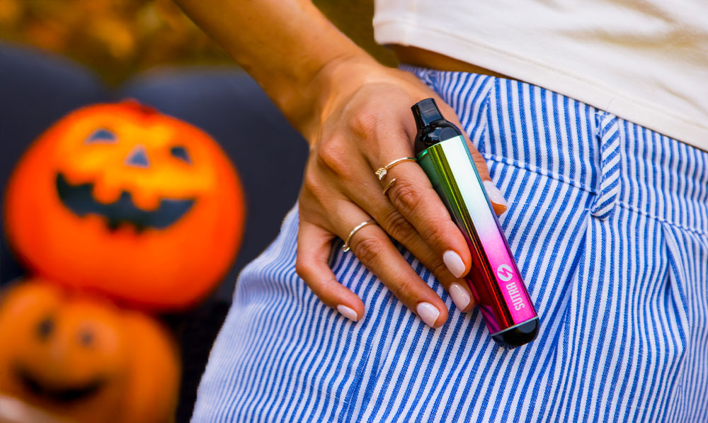 woman holding sutra silo with pumpkins in background
